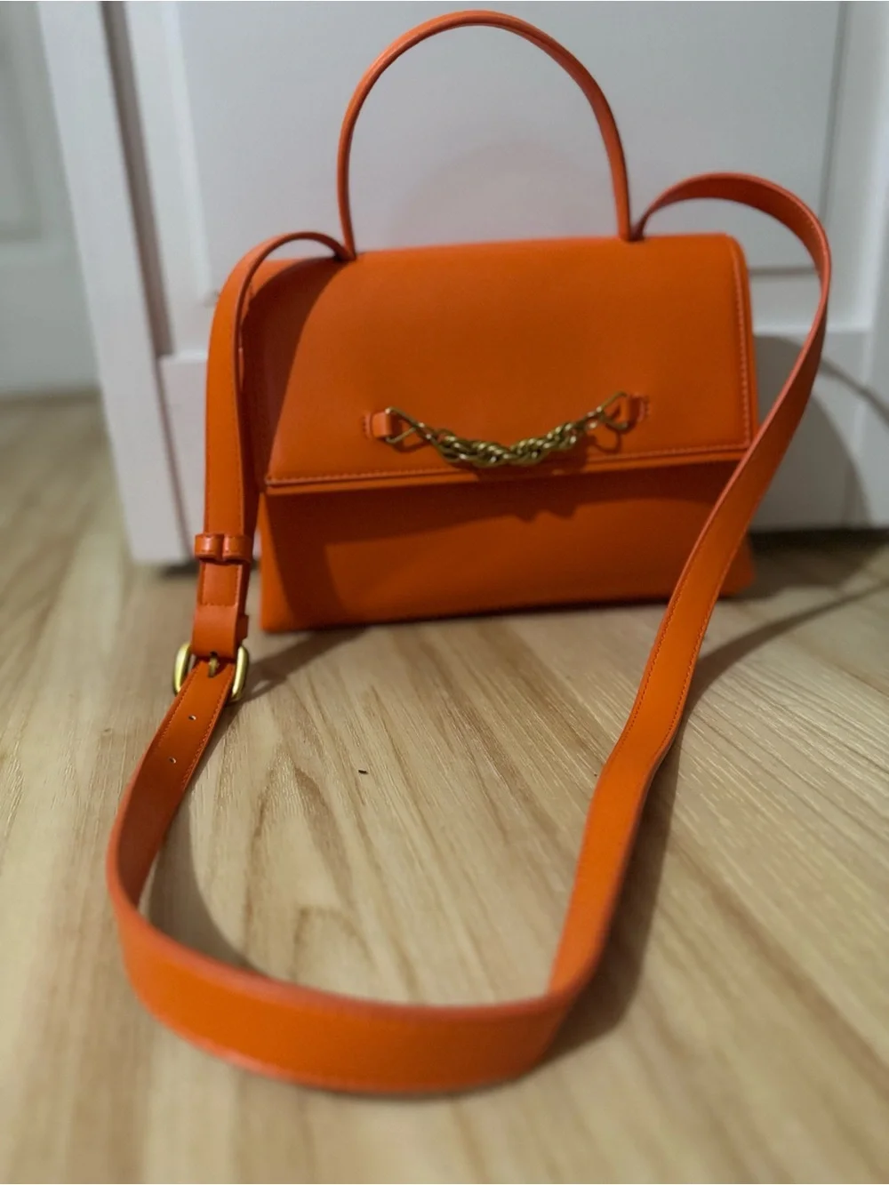 Structured Orange Leather Satchel with Gold Chain Accent